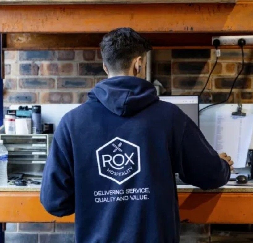 Jack Scott working at an operations desk in the Rox Hospitality warehouse